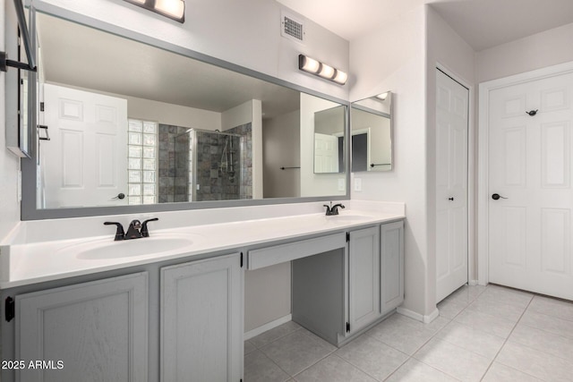 full bathroom featuring tile patterned floors, a stall shower, double vanity, and baseboards