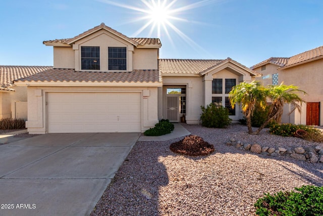 view of front of house with a tiled roof, stucco siding, driveway, and an attached garage