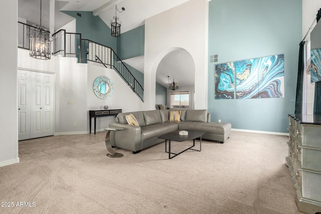 carpeted living area with high vaulted ceiling, a chandelier, baseboards, stairs, and beamed ceiling