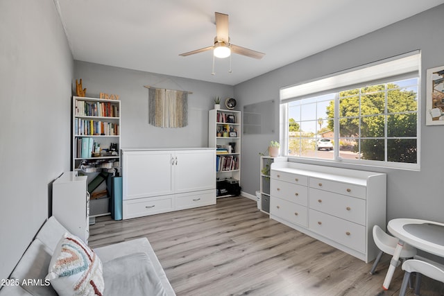 bedroom featuring light wood-type flooring and a ceiling fan