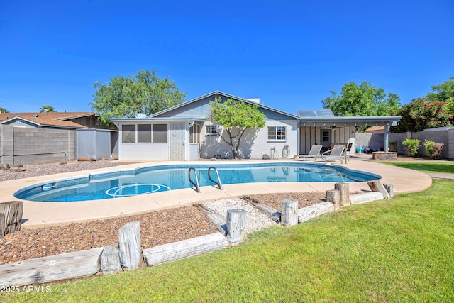 view of pool featuring a fenced in pool, a patio area, a fenced backyard, a yard, and a sunroom
