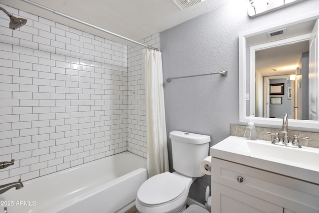bathroom featuring vanity, visible vents, toilet, shower / bath combo with shower curtain, and a textured wall