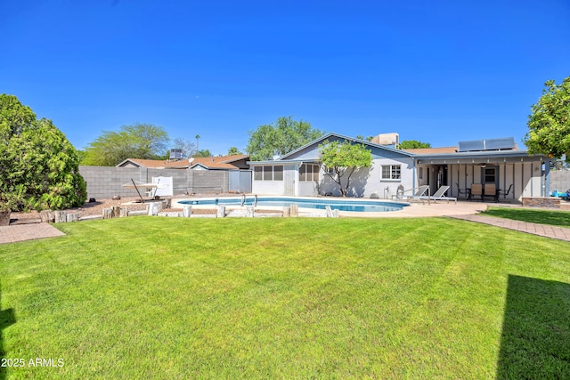 view of swimming pool featuring a fenced in pool, a yard, a fenced backyard, and a patio area