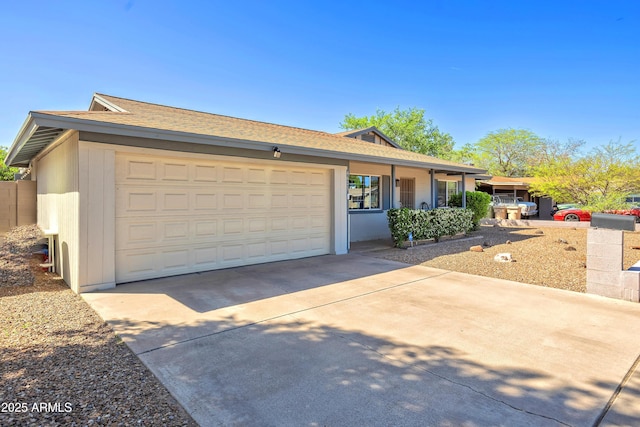 single story home with roof with shingles, driveway, and a garage