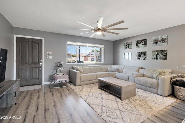living room with ceiling fan and wood finished floors