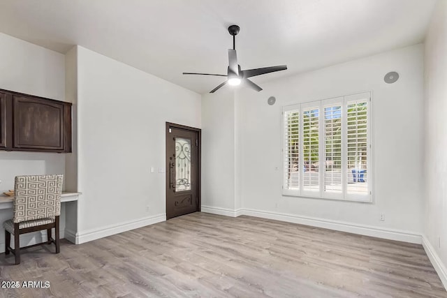 entrance foyer with baseboards, light wood-style flooring, and ceiling fan