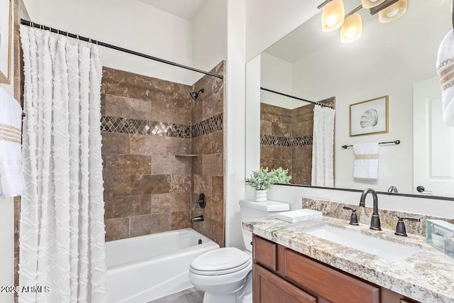 bathroom featuring toilet, vanity, and shower / bath combo