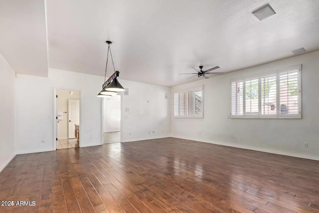 unfurnished living room with hardwood / wood-style floors, baseboards, and a ceiling fan