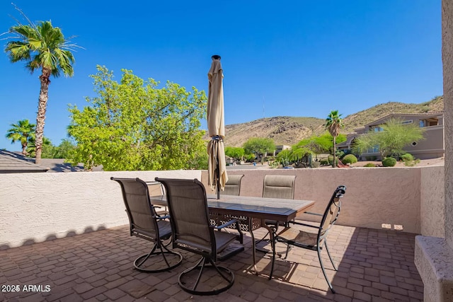 view of patio featuring outdoor dining area and a mountain view