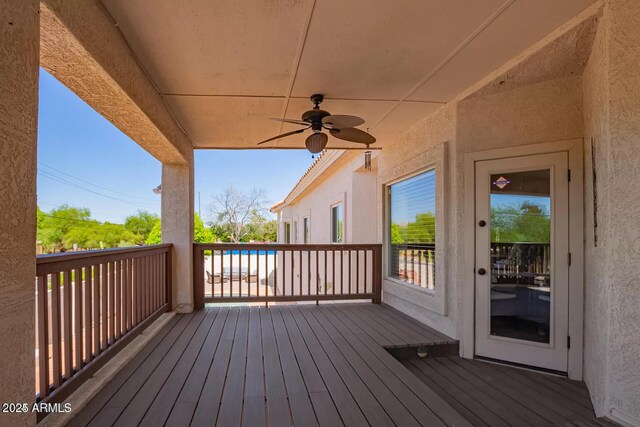 wooden terrace with a ceiling fan