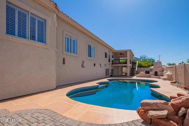 view of pool with fence, stairs, ceiling fan, a fenced in pool, and a patio area