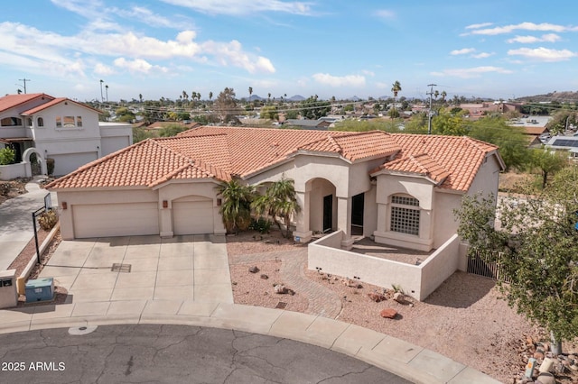 mediterranean / spanish-style house with stucco siding, a tile roof, a garage, and fence