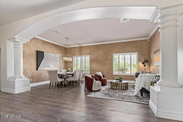 living room with ornamental molding, wood finished floors, and decorative columns
