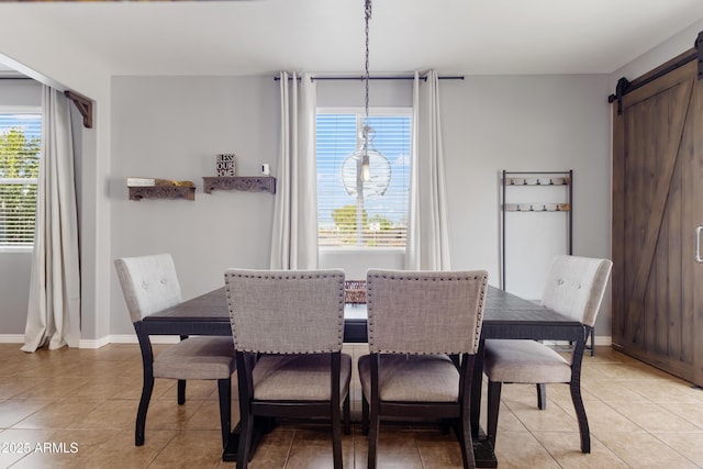 7305 W Darrel Rd, Laveen, AZ 85339 - dining space featuring light tile patterned floors, a barn door, and baseboards