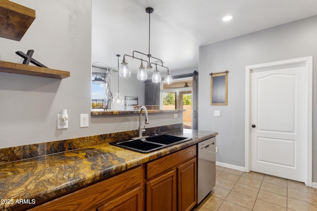 7305 W Darrel Rd, Laveen, AZ 85339 - kitchen with dishwasher, a sink, brown cabinets, baseboards, and light tile patterned floors