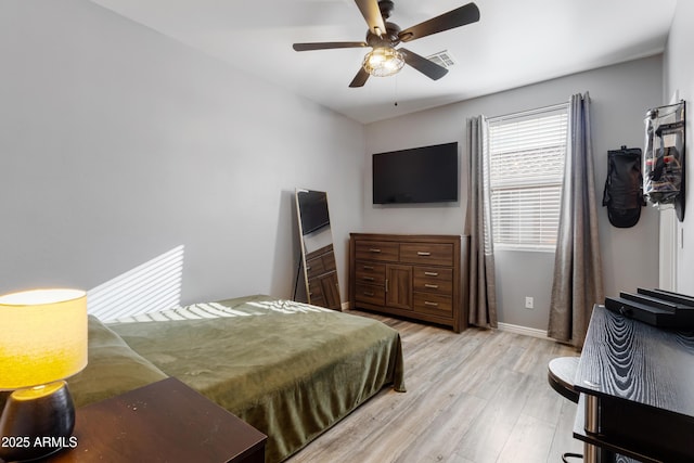 7305 W Darrel Rd, Laveen, AZ 85339 - bedroom with light wood-style floors, baseboards, and a ceiling fan