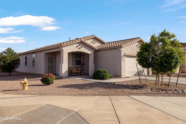 7305 W Darrel Rd, Laveen, AZ 85339 - mediterranean / spanish house featuring an attached garage, stucco siding, and a tiled roof