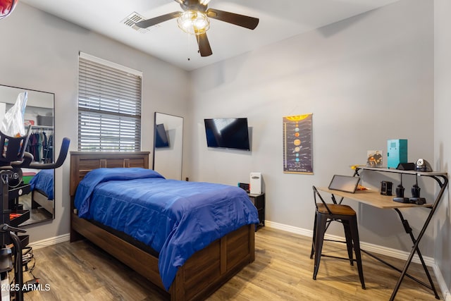 7305 W Darrel Rd, Laveen, AZ 85339 - bedroom with baseboards, wood finished floors, and a ceiling fan