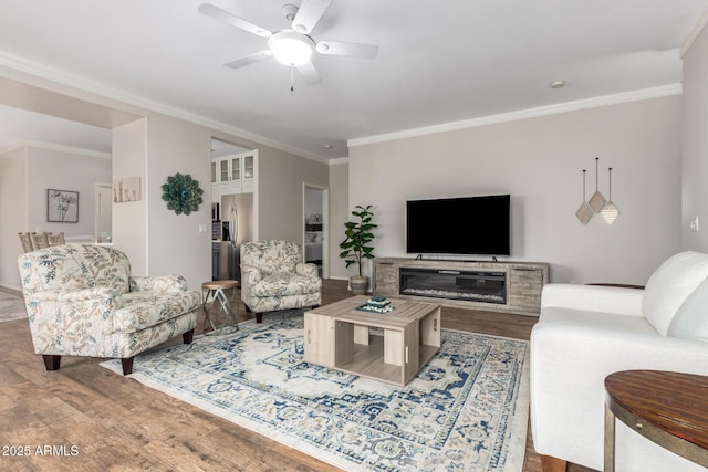 living room featuring crown molding, ceiling fan, and hardwood / wood-style floors