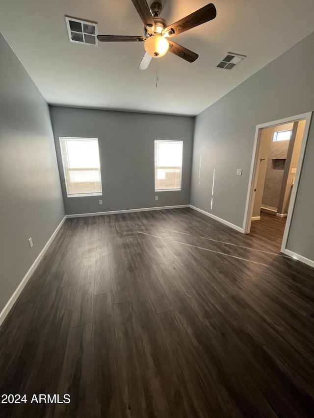 empty room featuring ceiling fan and dark wood-type flooring