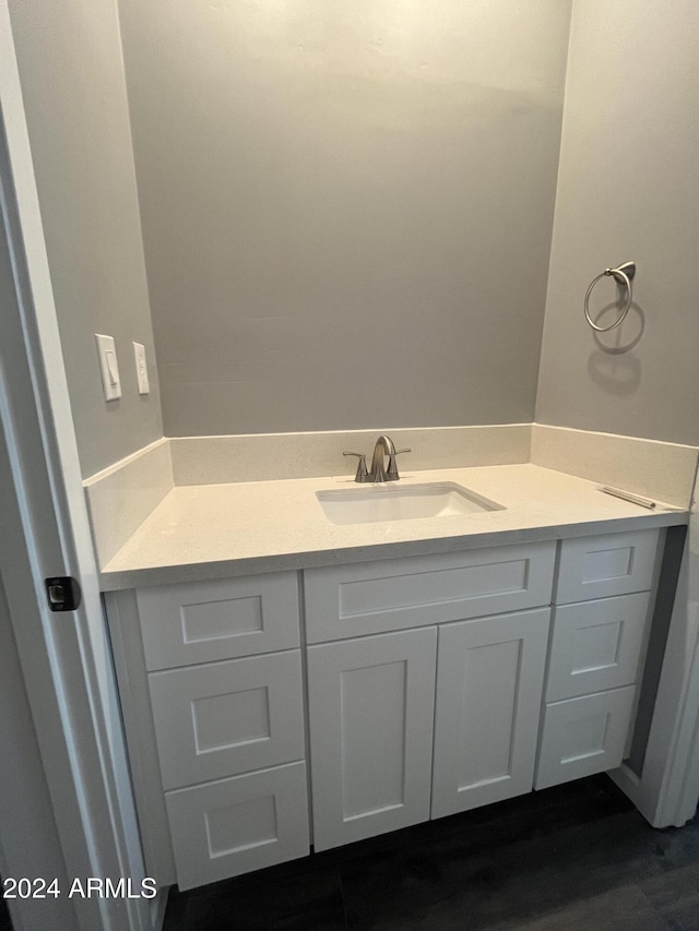 bathroom with hardwood / wood-style floors and vanity