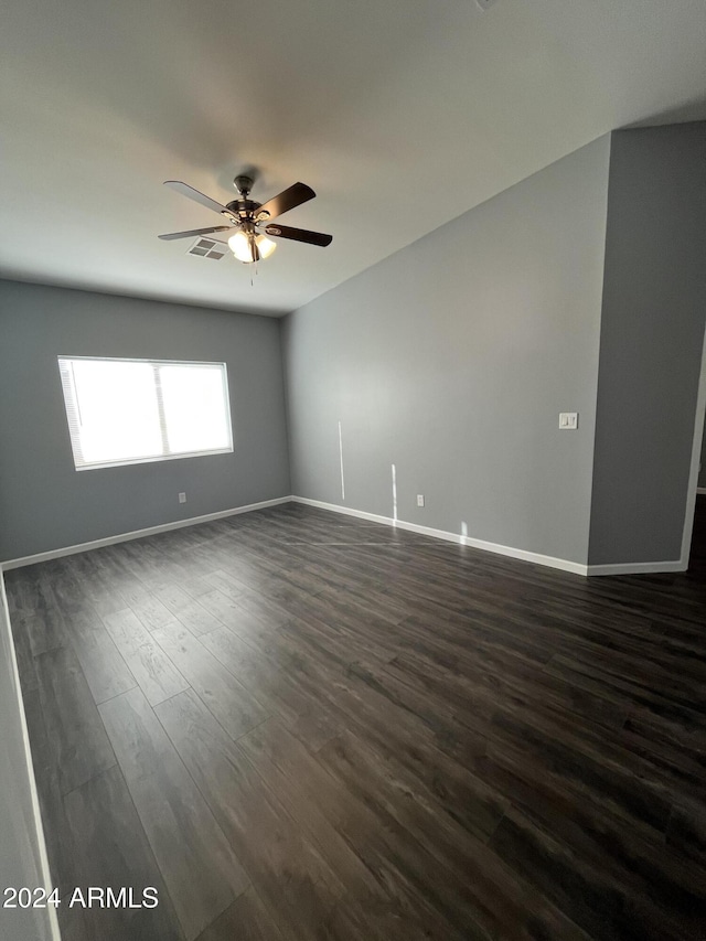 empty room with dark hardwood / wood-style floors and ceiling fan