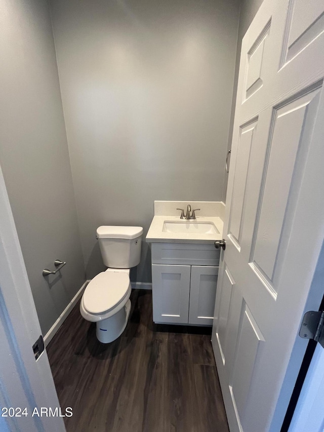 bathroom featuring hardwood / wood-style floors, vanity, and toilet