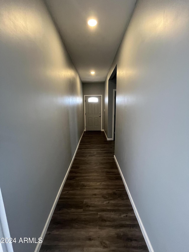 hallway with dark hardwood / wood-style flooring