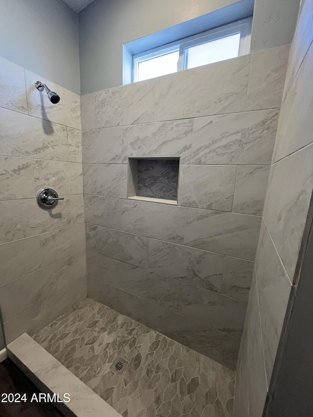 bathroom with a tile shower