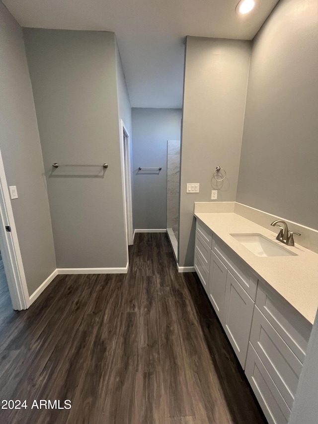 bathroom with vanity, wood-type flooring, and walk in shower