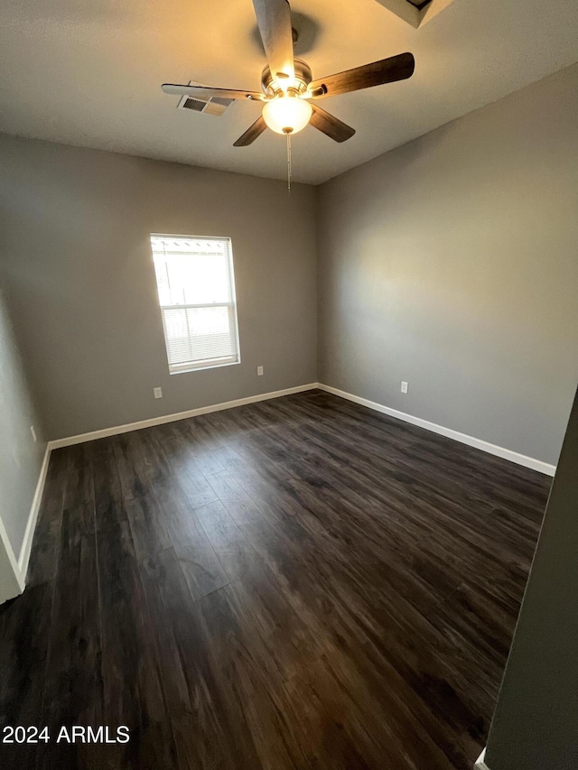 spare room with ceiling fan and dark wood-type flooring