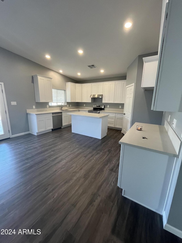 kitchen with a center island, white cabinets, sink, dark hardwood / wood-style flooring, and stainless steel appliances