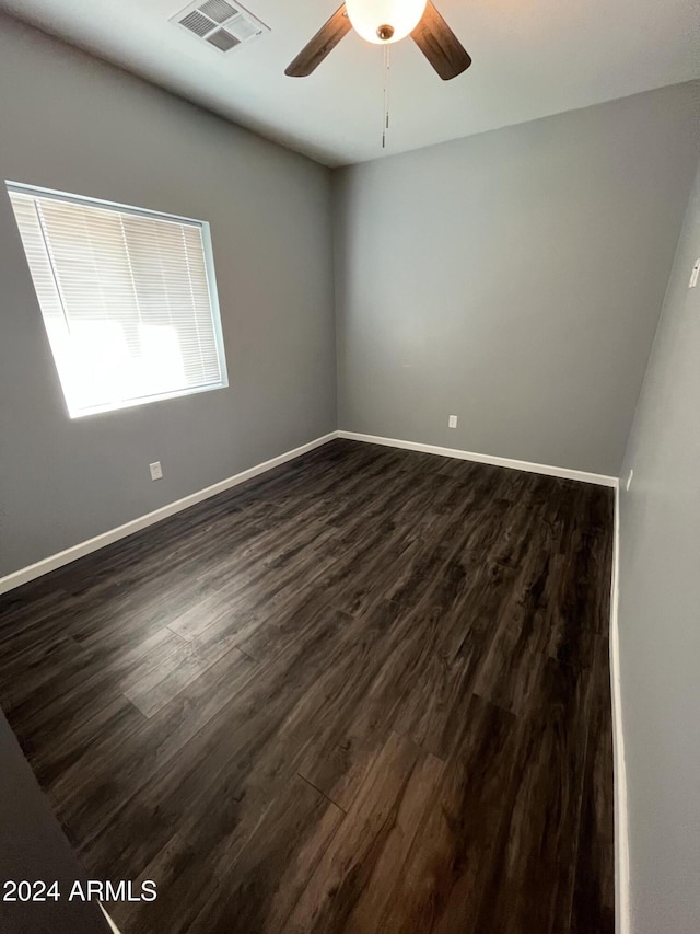 spare room featuring dark hardwood / wood-style floors and ceiling fan