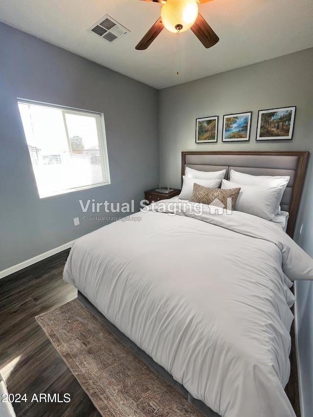 bedroom featuring ceiling fan and dark wood-type flooring