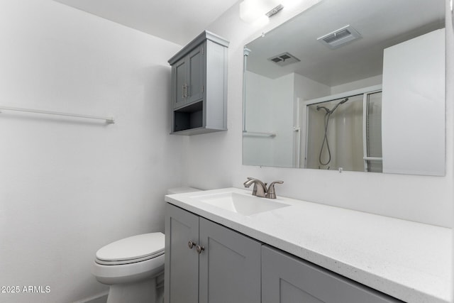 bathroom with toilet, an enclosed shower, and vanity