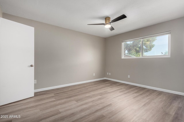 empty room with ceiling fan and light wood-type flooring