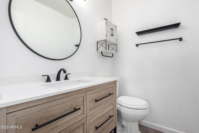 bathroom with toilet and vanity