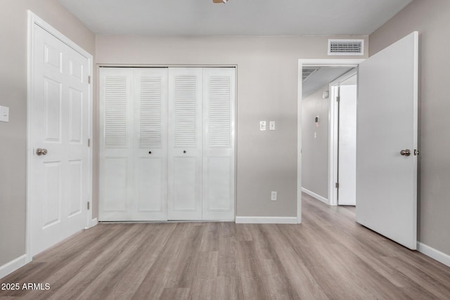 unfurnished bedroom featuring a closet and light hardwood / wood-style flooring