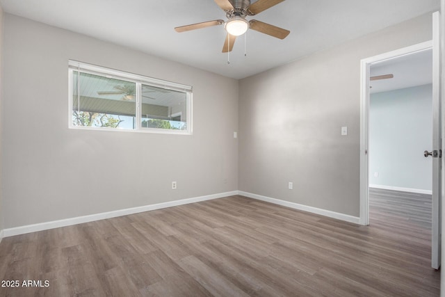 empty room featuring ceiling fan and hardwood / wood-style flooring