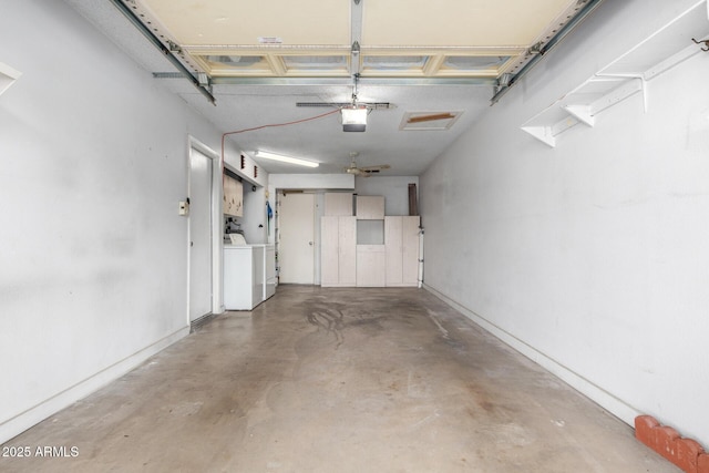 garage with washing machine and dryer and a garage door opener