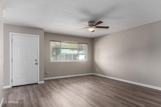 empty room with ceiling fan, a textured ceiling, and hardwood / wood-style flooring