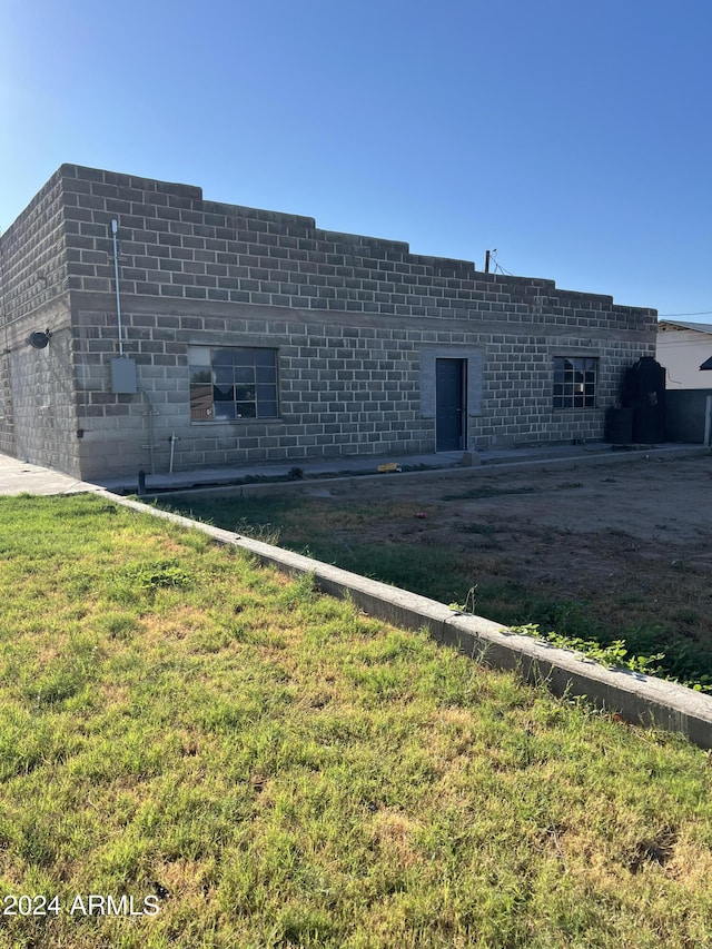 view of side of property with a yard