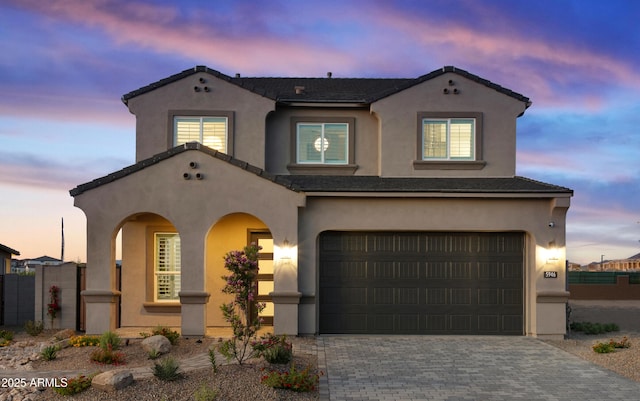 17831 W Mission Ln, Waddell, AZ 85355 - mediterranean / spanish home with decorative driveway, a garage, stucco siding, and fence