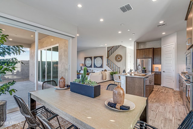 17831 W Mission Ln, Waddell, AZ 85355 - dining area with stairs, recessed lighting, visible vents, and light wood-style floors