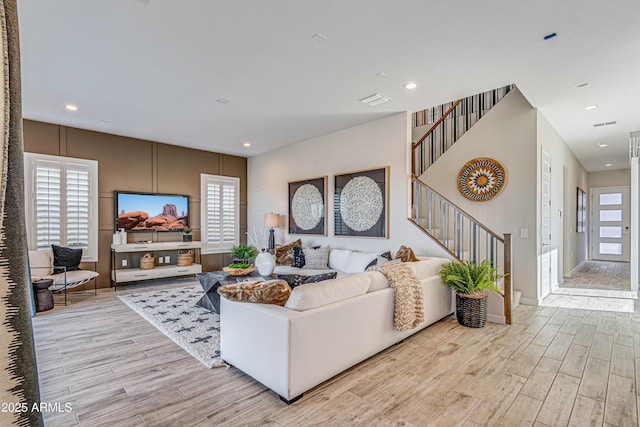 17831 W Mission Ln, Waddell, AZ 85355 - living room featuring a healthy amount of sunlight, wood finished floors, and stairway