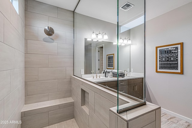 17831 W Mission Ln, Waddell, AZ 85355 - bathroom featuring double vanity, visible vents, walk in shower, wood finished floors, and a sink