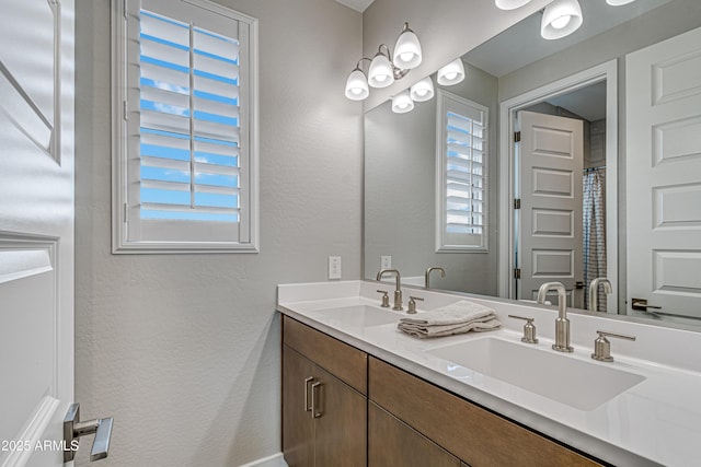 17831 W Mission Ln, Waddell, AZ 85355 - full bath featuring a sink, a textured wall, and double vanity
