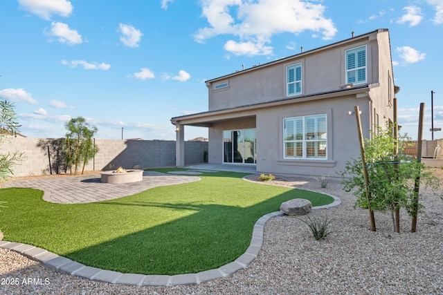 17831 W Mission Ln, Waddell, AZ 85355 - rear view of property with an outdoor fire pit, stucco siding, a fenced backyard, a patio, and a yard