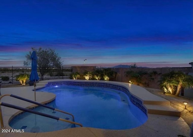 view of pool at dusk