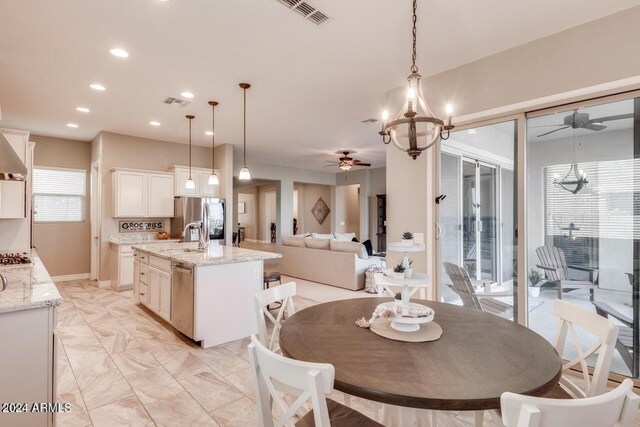 dining space featuring a notable chandelier and sink